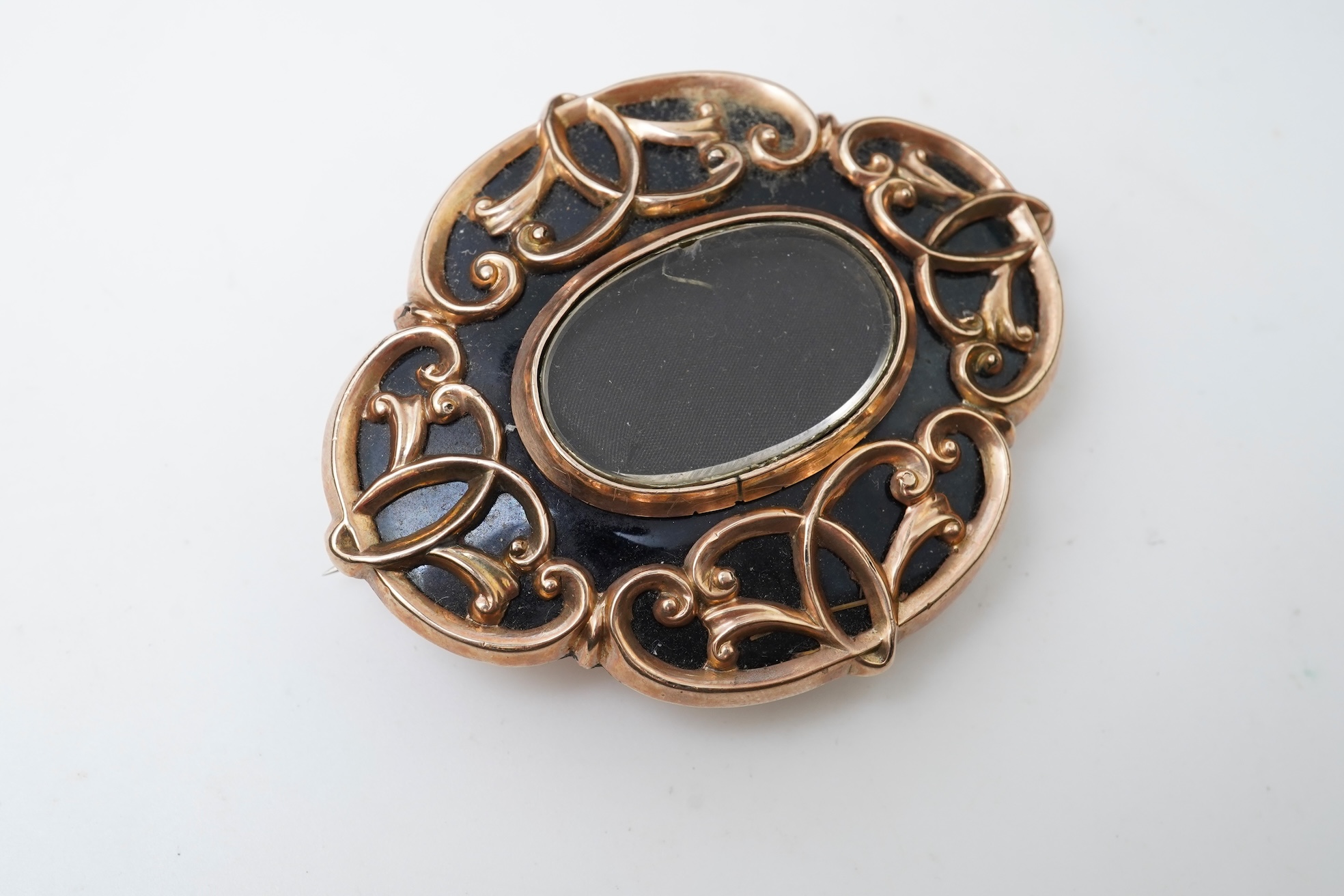 A Victorian rolled gold and enamel locket brooch/pendant, late 19th century